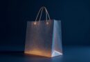 Translucent digital shopping bag woven from gold neural threads, indigo glow.